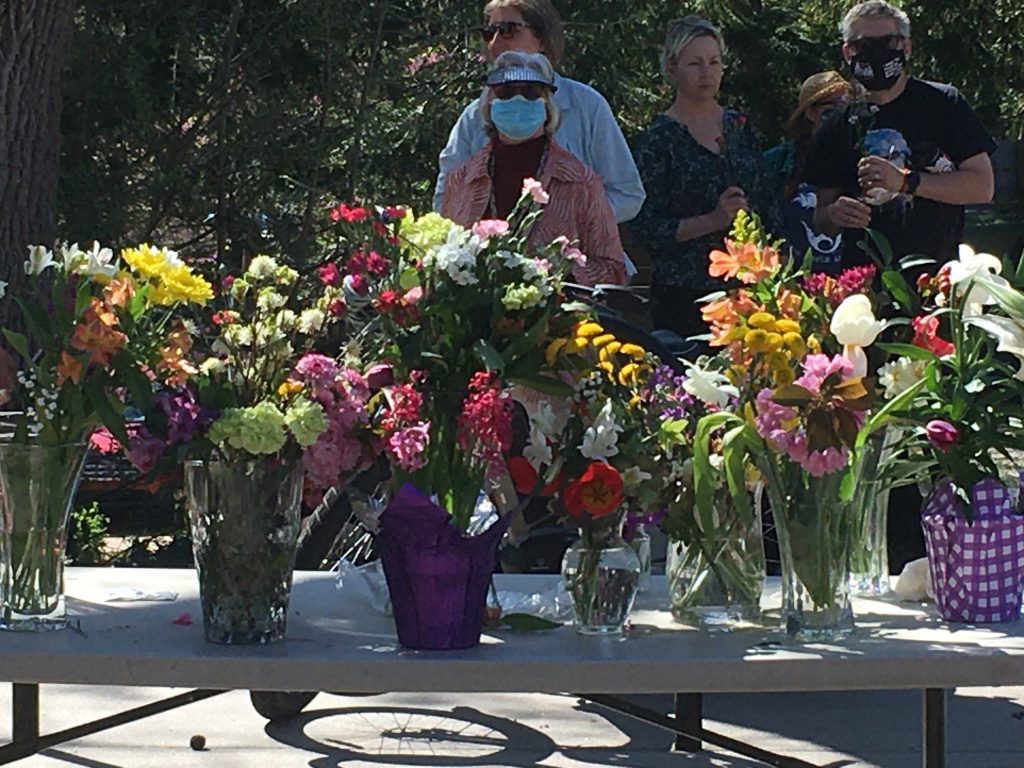 Table showing vases of flowers at a church event