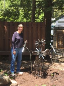 Photograph of Gail Hyde next to her scupture.