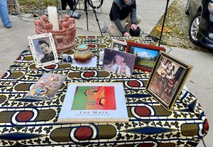 Tabletop with printed cloh an photos of people to be remembered.