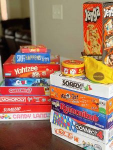 two piles of board games on a table