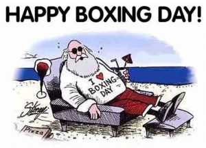 santa claus sitting on a lounge chair on a beach with a sweatshirt that says I heart Boxing Day