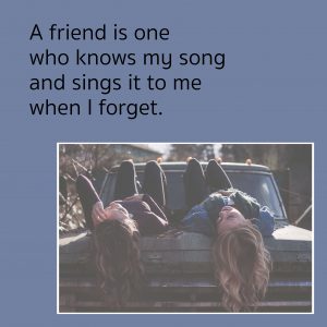 Two young people with headsvhanging off of a couch, "A friend is one who knows my song and sings it to me when I forget.