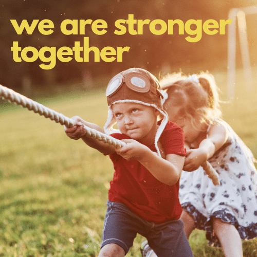 young boy and girl pulling on rope on one side of tug-a-war